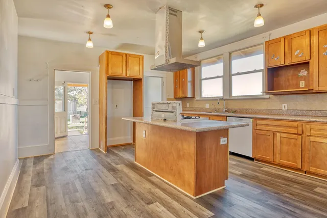 a kitchen with stainless steel appliances granite countertop a sink and cabinets