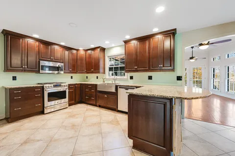 a kitchen with stainless steel appliances granite countertop a refrigerator and a sink