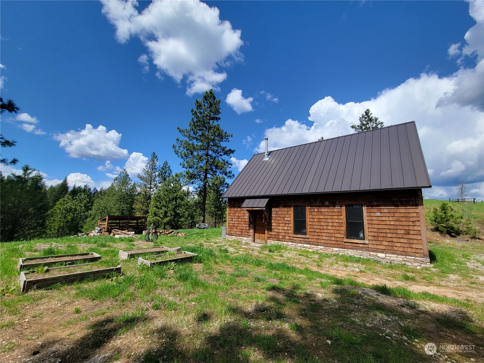 5099 M Allen Road Springdale, WA 99173 - Photo 3 of 38 a backyard of a house with table and chairs