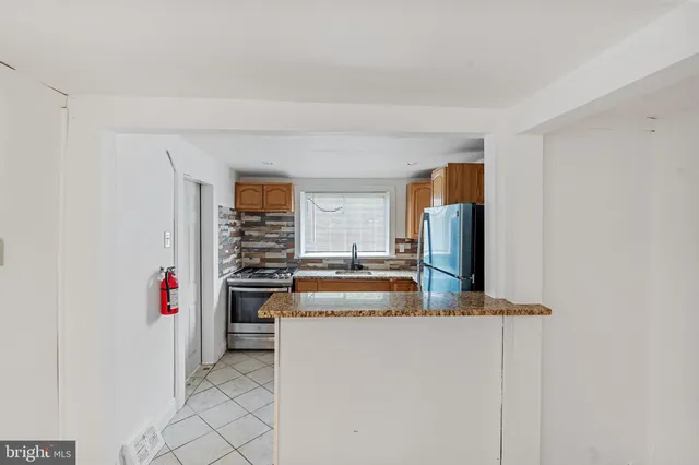 a kitchen with stainless steel appliances a stove and a refrigerator
