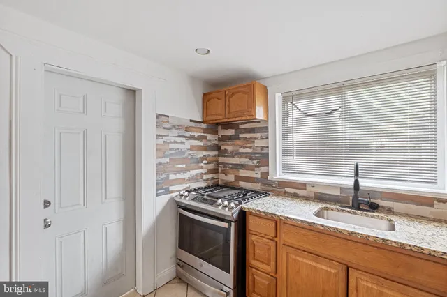 a kitchen with granite countertop a sink and a window