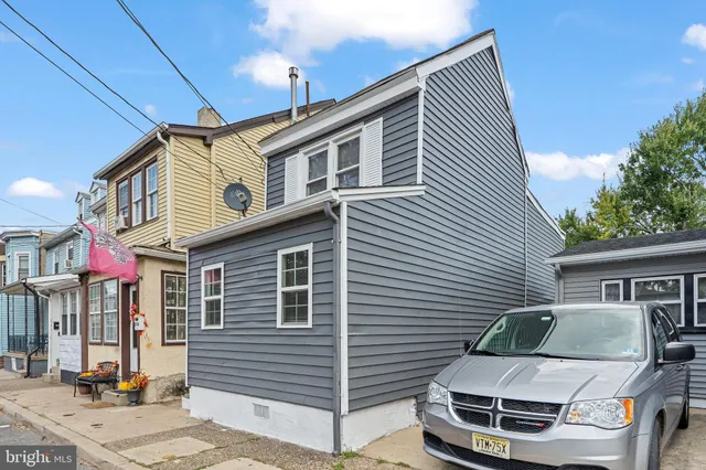 a white building with a large window and balcony
