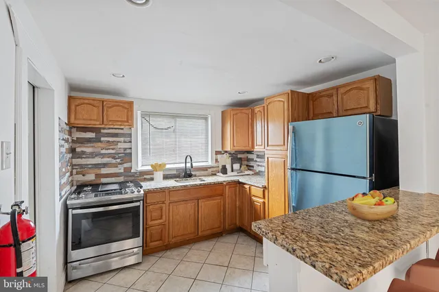 a kitchen with a sink a stove and refrigerator
