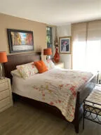 a bedroom with a bed and glass windows