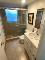 a bathroom with a sink toilet and shower