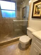 a bathroom with a toilet and a shower