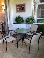 a view of a patio with table and chairs with plants