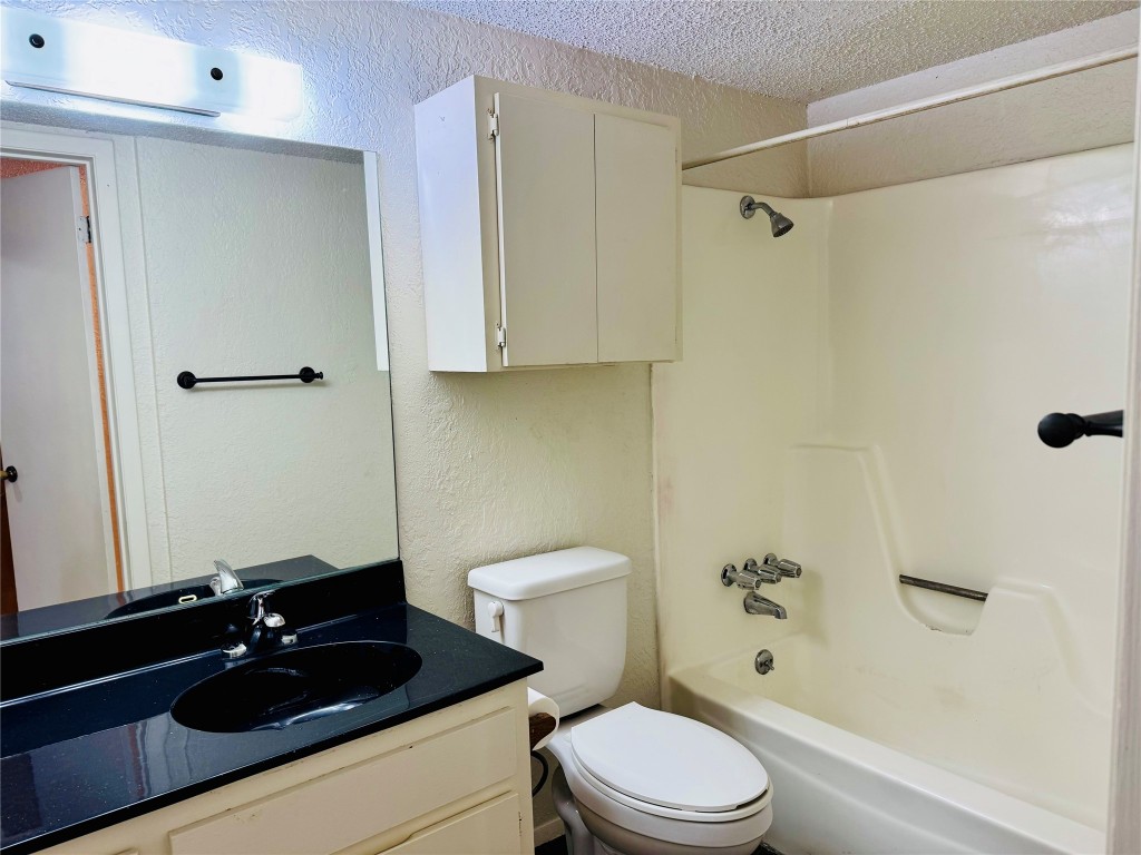 907 Milford Way, Unit A Austin, TX 78745 - Photo 12 of 16 a bathroom with a sink a toilet and shower