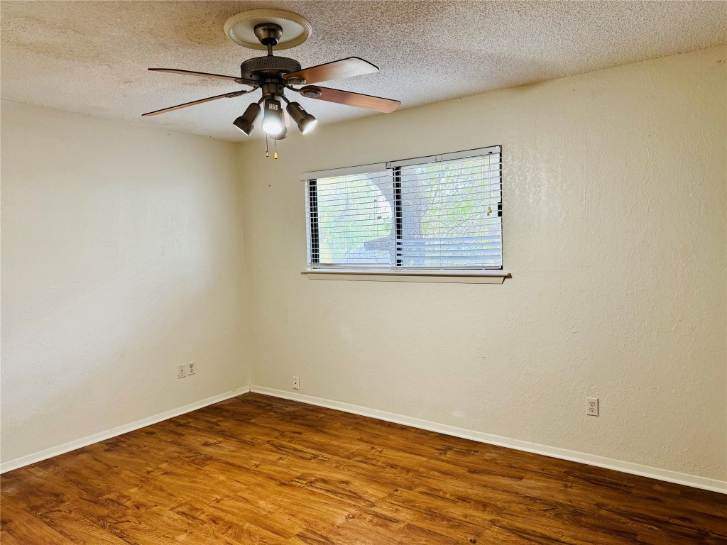 907 Milford Way, Unit A Austin, TX 78745 - Photo 6 of 16 a view of empty room with wooden floor
