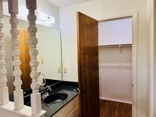 a bathroom with a sink a mirror and shower