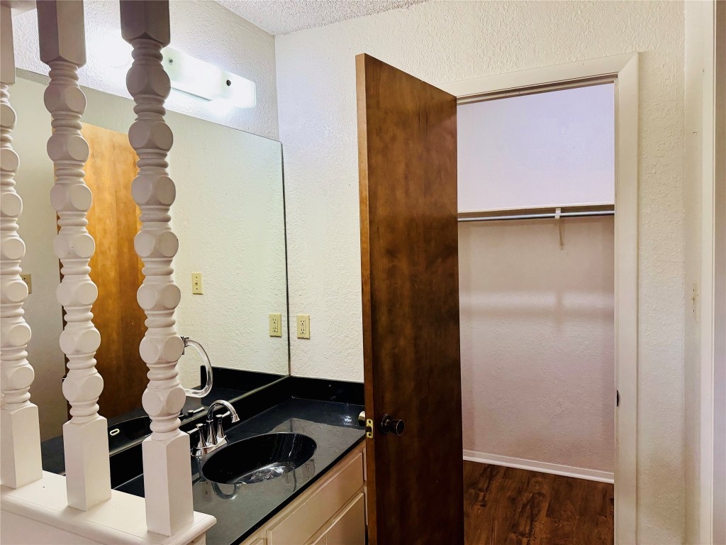 907 Milford Way, Unit A Austin, TX 78745 - Photo 7 of 16 a bathroom with a sink a mirror and shower