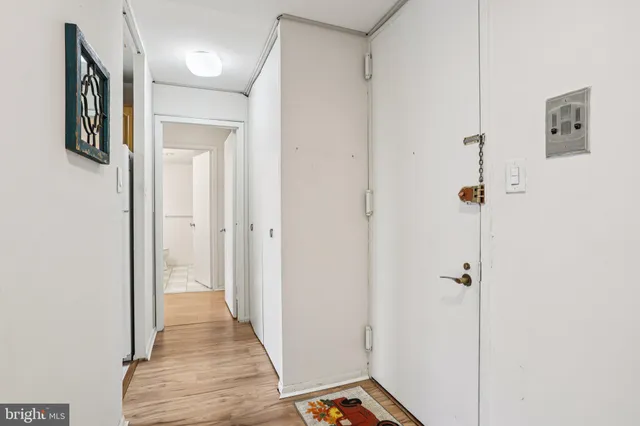 a view of a hallway with wooden floor