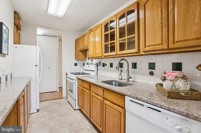 a kitchen with stainless steel appliances granite countertop a sink and cabinets