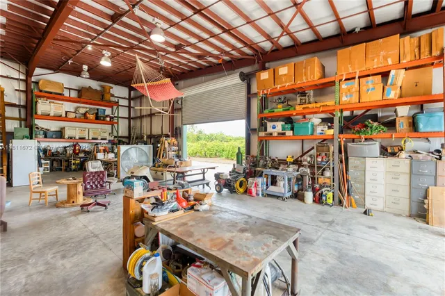 a kitchen with stainless steel appliances granite countertop a refrigerator a sink dishwasher a stove and white cabinets with wooden floor