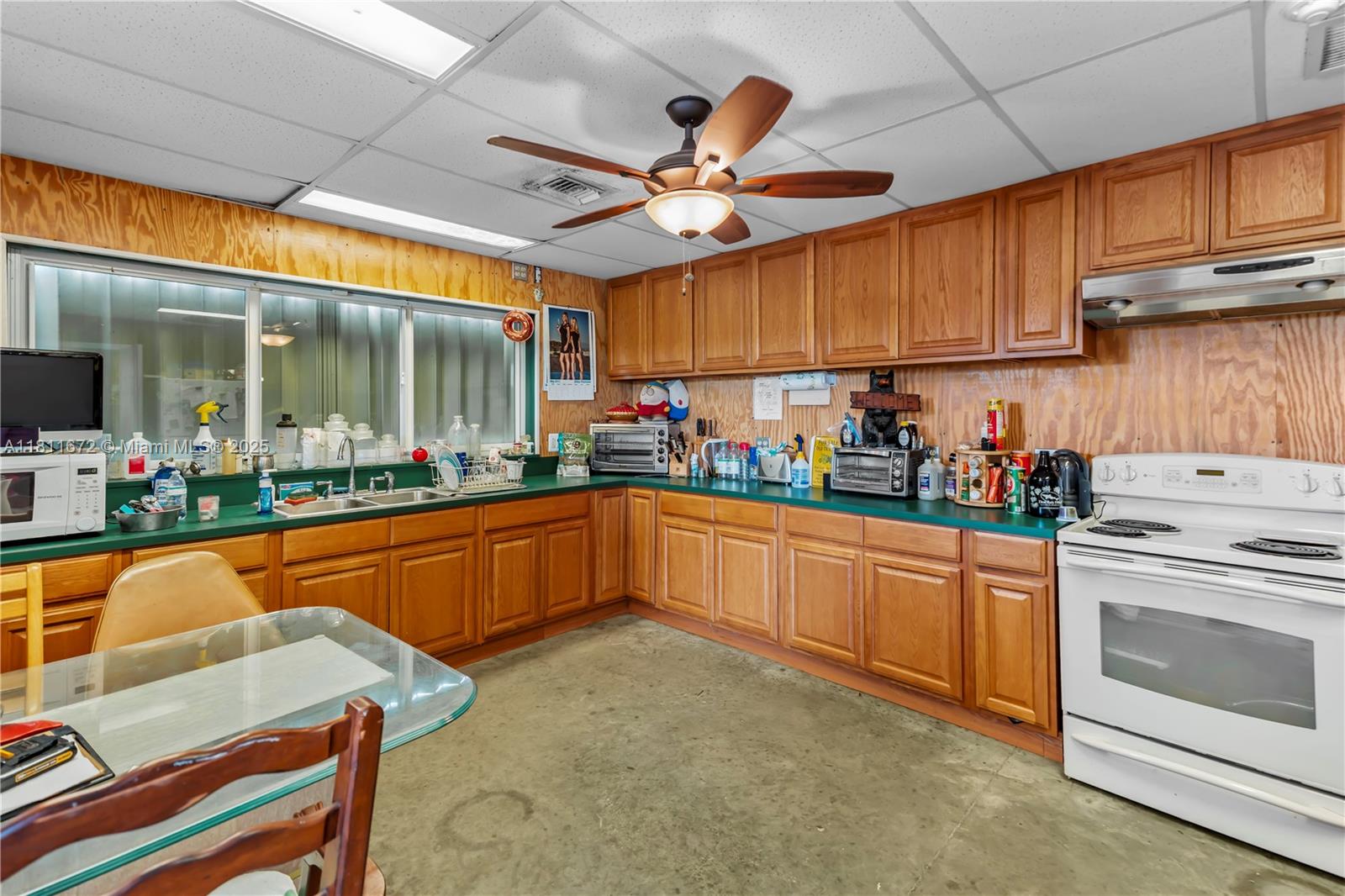 4077 Southwest 121st Terrace Davie, FL 33330 - Photo 13 of 85 a kitchen with stainless steel appliances granite countertop a sink a stove and a refrigerator