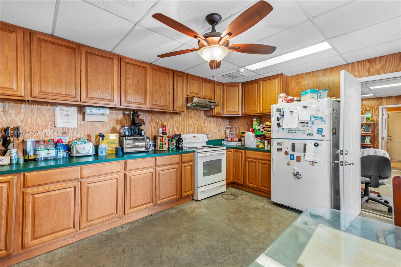 4077 Southwest 121st Terrace Davie, FL 33330 - Photo 15 of 85 a kitchen with stainless steel appliances granite countertop a refrigerator a sink dishwasher a stove and white cabinets with wooden floor