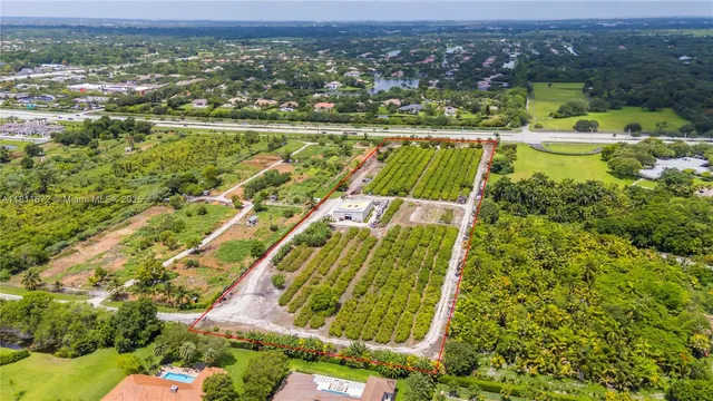 an aerial view of a houses with outdoor space and swimming pool