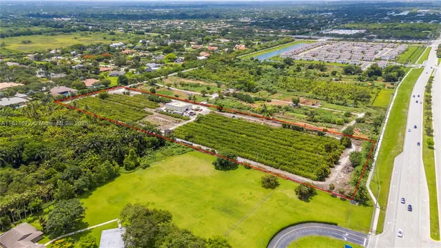 an aerial view of residential houses with outdoor space and river