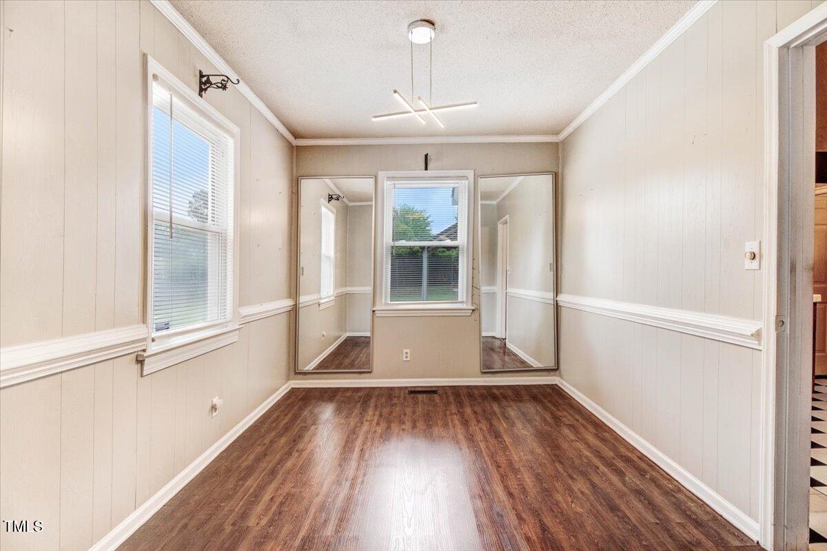 607 East Geer Street Durham, NC 27701 - Photo 11 of 23 a view of empty room with wooden floor and fan