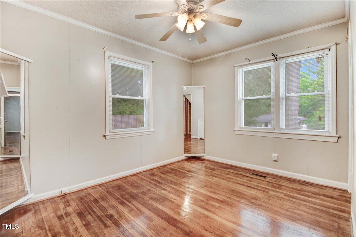 607 East Geer Street Durham, NC 27701 - Photo 12 of 23 a view of an empty room with wooden floor and a window