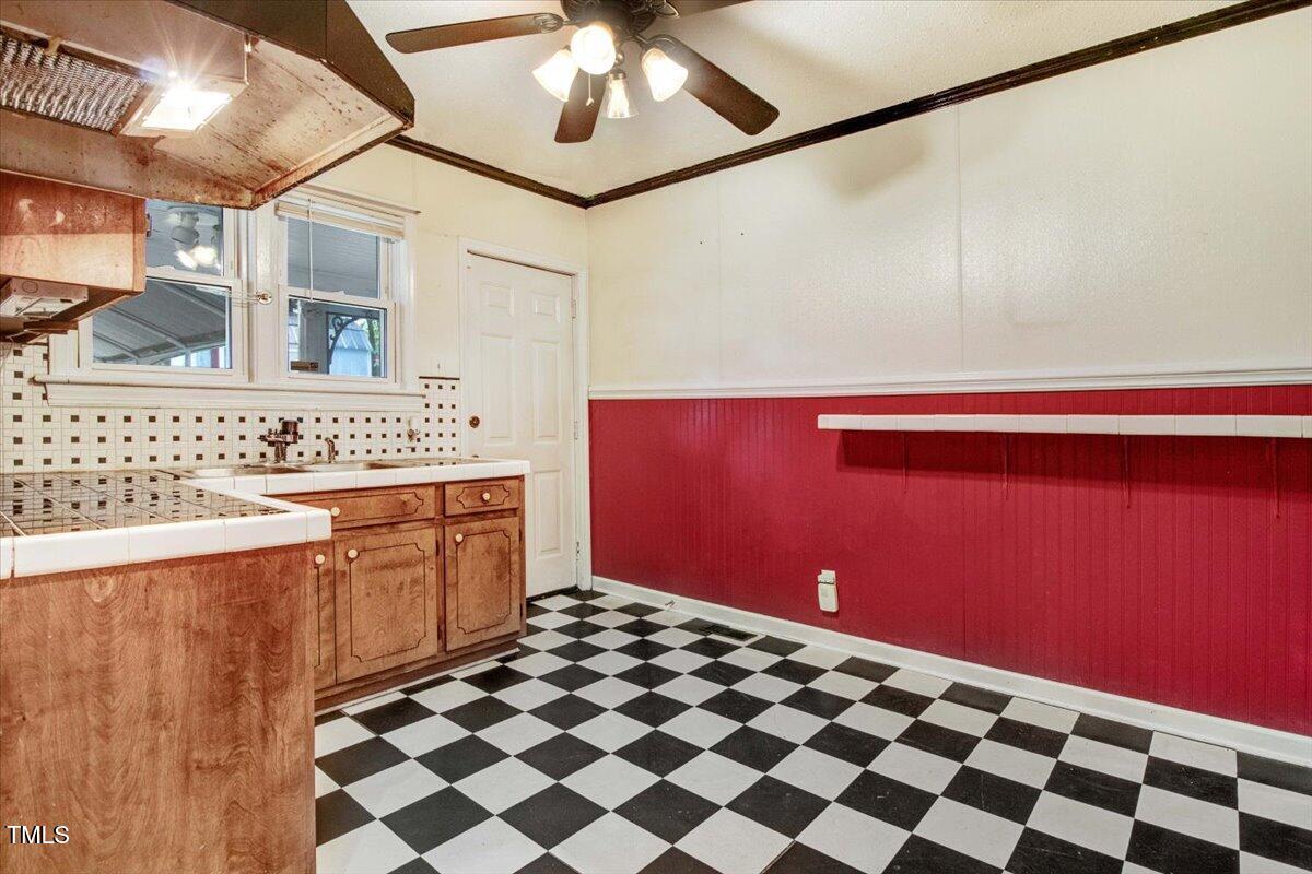 607 East Geer Street Durham, NC 27701 - Photo 17 of 23 a kitchen with a sink a stove cabinets and a shower