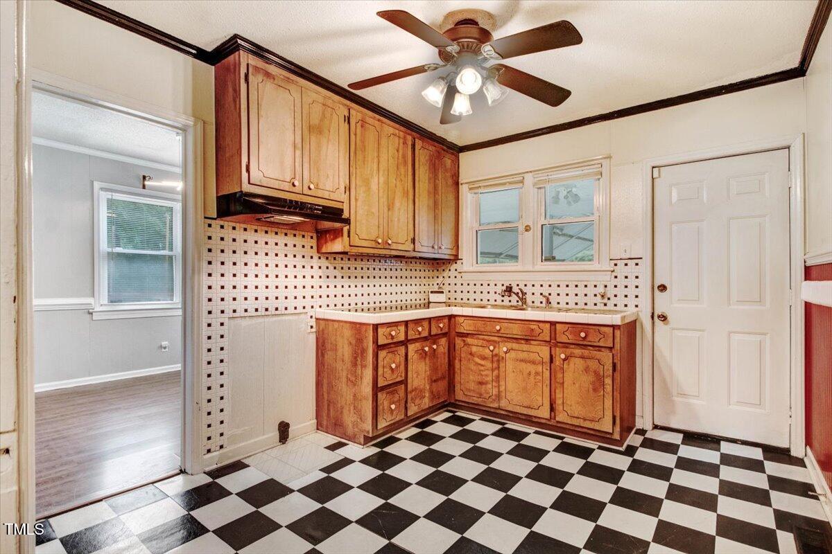 607 East Geer Street Durham, NC 27701 - Photo 18 of 23 a kitchen with stainless steel appliances granite countertop a refrigerator a sink and wooden cabinets