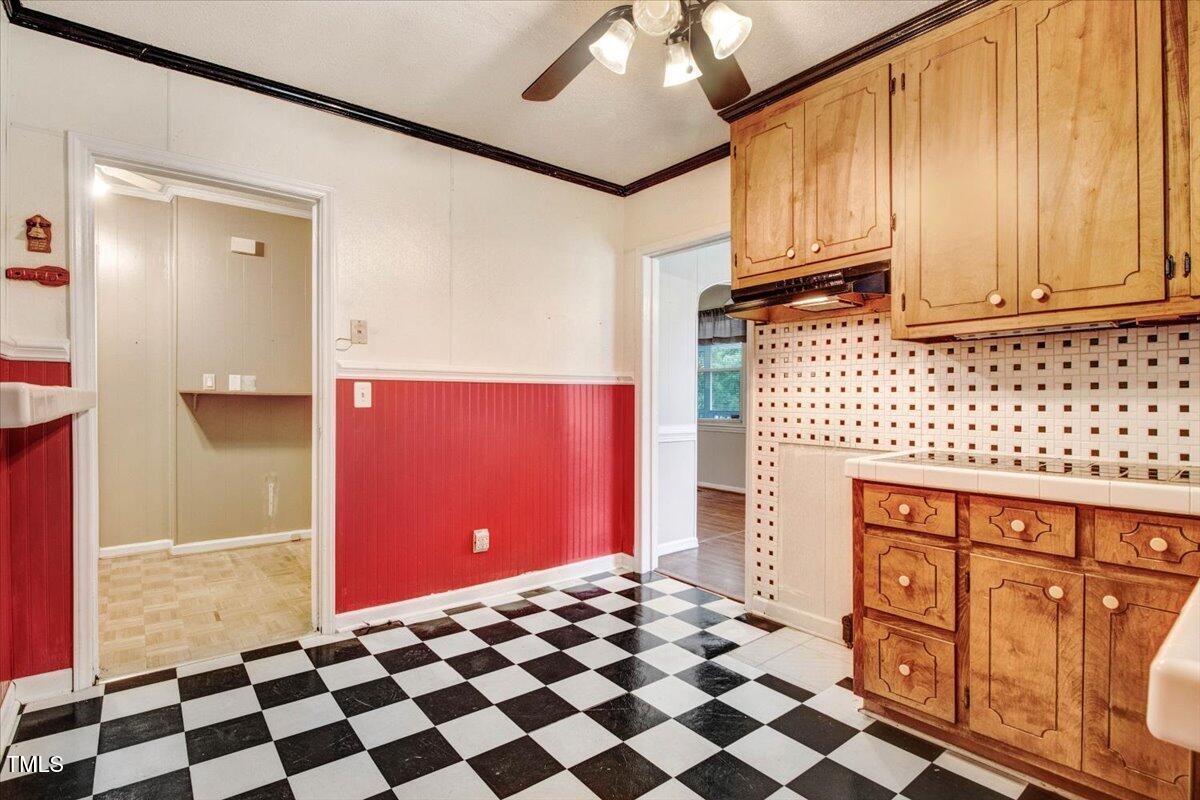 607 East Geer Street Durham, NC 27701 - Photo 19 of 23 a view of a refrigerator with wooden cabinets