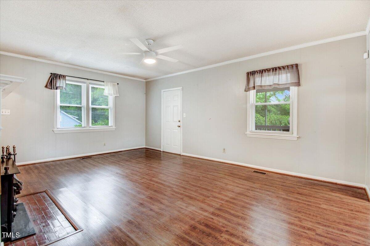 607 East Geer Street Durham, NC 27701 - Photo 10 of 23 an empty room with wooden floor and windows