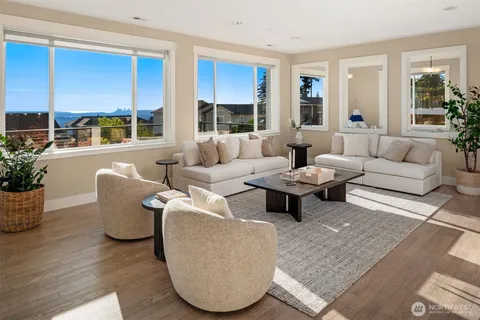 a living room with furniture potted plant and a large window