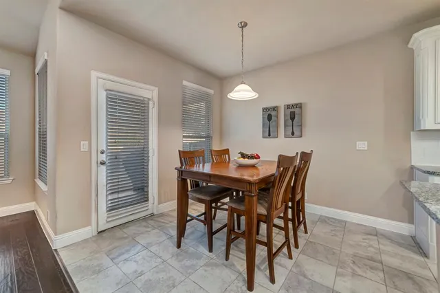 a view of a dining room with furniture and a chandelier