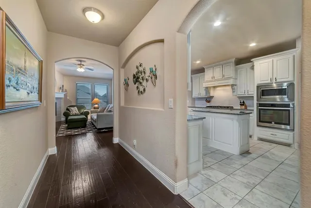 a kitchen with a refrigerator and a stove top oven