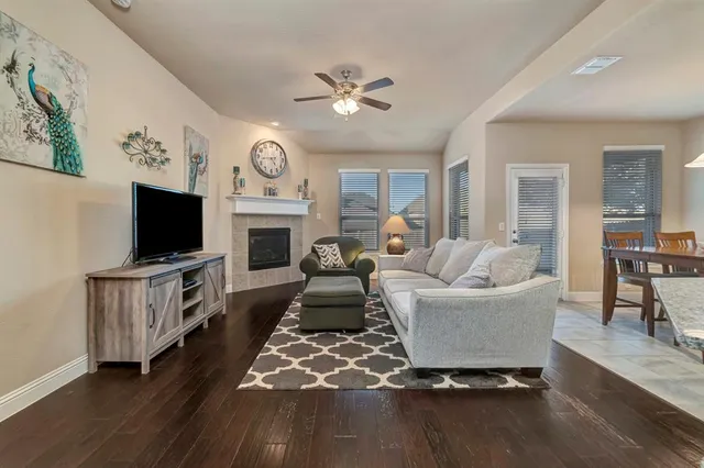 a living room with furniture a flat screen tv and a fireplace