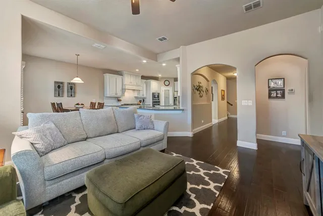 a living room with furniture and wooden floor