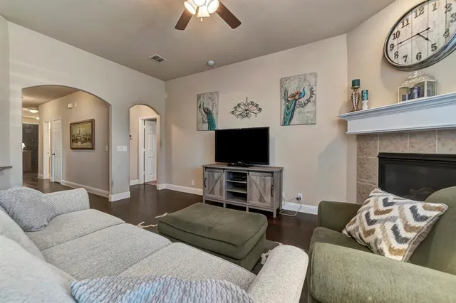 a living room with furniture a flat screen tv and a fireplace