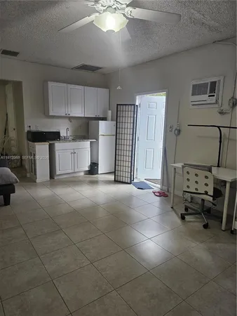 a living room with furniture and kitchen view