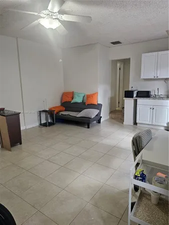 a kitchen with a sink a stove and a refrigerator