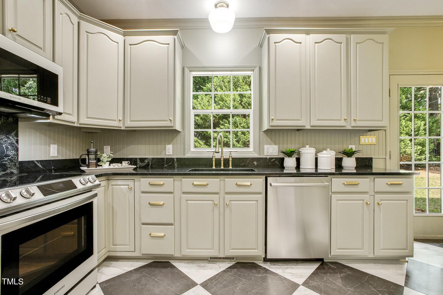 106 Tawny Ridge Lane Cary, NC 27513 - Photo 8 of 19 a kitchen with granite countertop white cabinets and white appliances