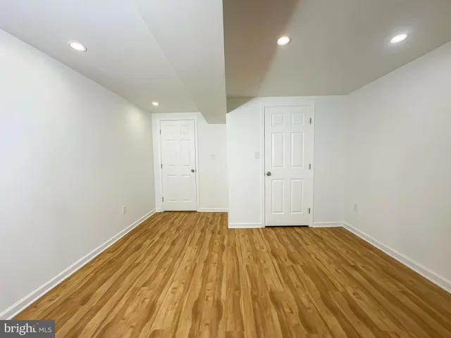a view of a room with wooden floor and white walls