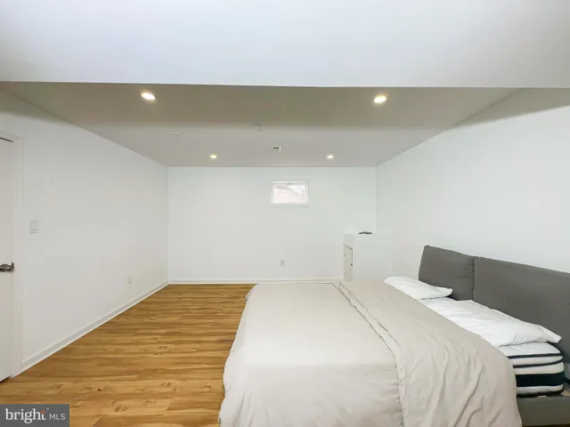 a bedroom with a bed and a night stand