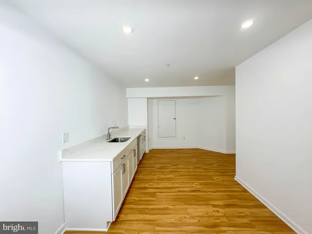 a view of a room with wooden floor