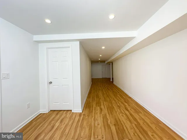 a view of a room with wooden floor