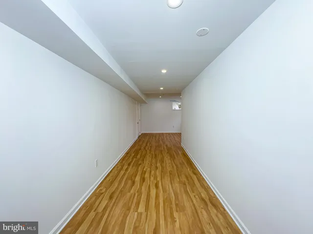 a view of wooden floor in a hallway