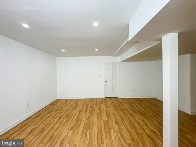 a view of room with wooden floor