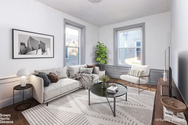a living room with furniture a wooden floor and a large window