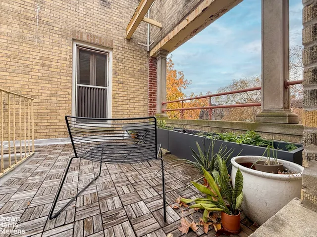 a view of a balcony with chairs and a table