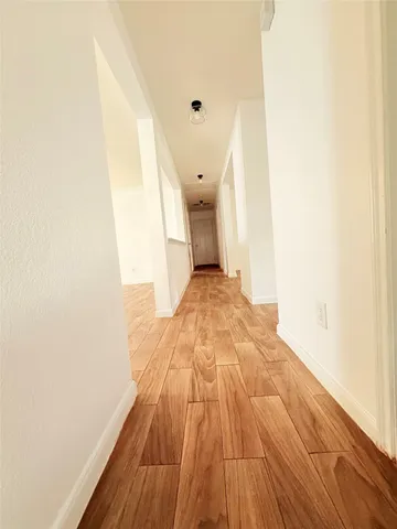 a view of a room with wooden floor