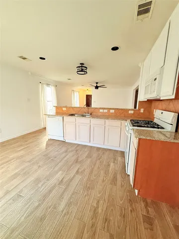 a kitchen with granite countertop a stove and a sink