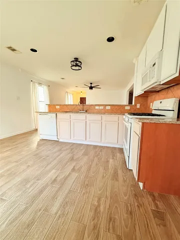 a view of a kitchen with wooden floor