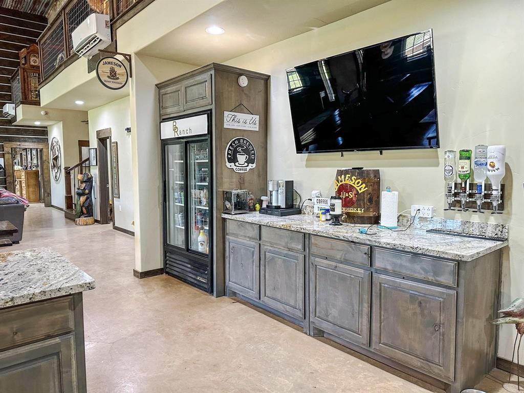 1990 Jim Harry Loop Sunset, TX 76270 - Photo 7 of 39 a kitchen with stainless steel appliances granite countertop a sink stove and microwave