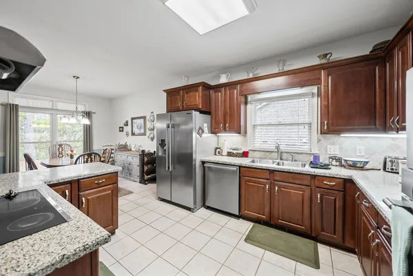 a kitchen with stainless steel appliances granite countertop a sink and cabinets